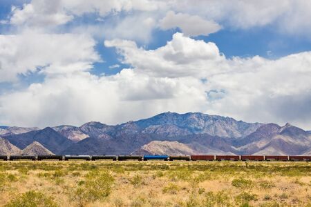 A cargo train traveling through the Mojave desert in Arizona.の写真素材