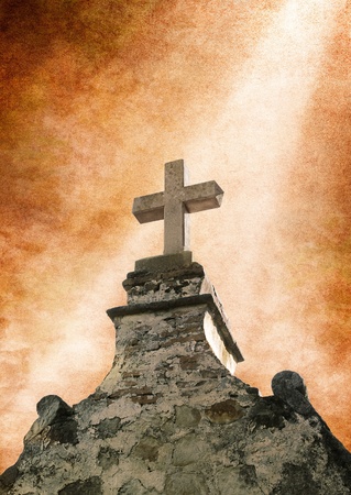 A beam of light on an ancient stone cross.の写真素材
