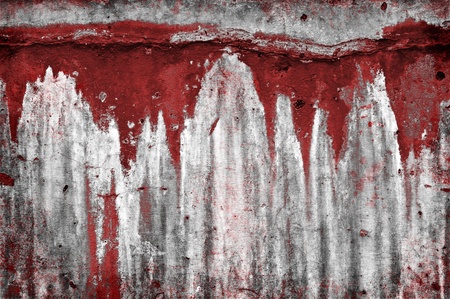An old eroded stone wall with red drip stains.の写真素材