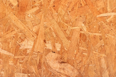 A close-up of mutli-layered plywood siding.