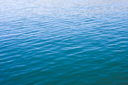 Surface water ripples with a dark to light gradation. 
