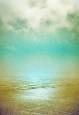 Sand and flowing ocean water disappearing into the horizon with swirling fog above   Image displays a pleasing grain pattern at 100 percent の写真素材