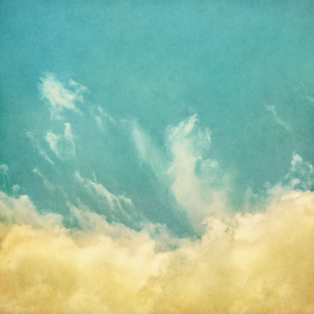 An abstraction of clouds and fog on a textured paper background with retro colors.  Image displays a strong paper grain and texture at 100 percent.の写真素材