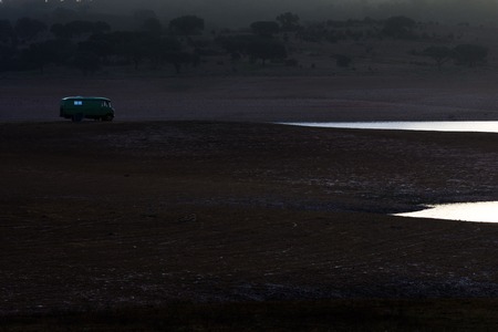Old motor home lonely at a lakeの写真素材