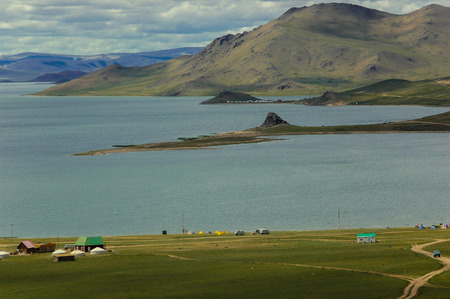 Camping tents at a lake in mongolian grassland natural landscapeの写真素材