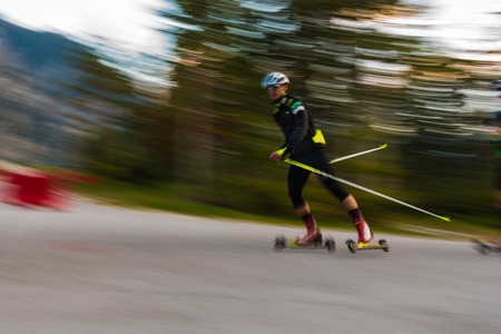 Athlete on roller skating rolls, Cross-country skiing with roller skis, time exposureのeditorial素材