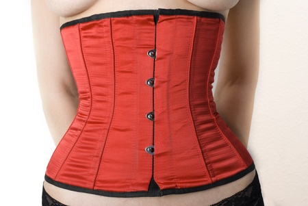 Closeup of a beautiful red corset on a girl.   の写真素材