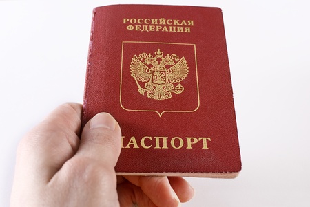 Russian international traveling passport in female hand over white background. Not isolated.の写真素材
