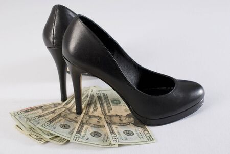 High heel shoes on money over white background. Not isolated.の写真素材