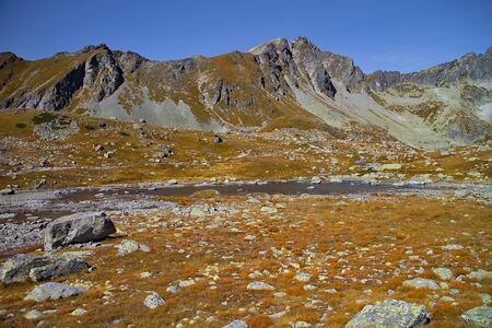 One of Hincove lakes in the High Tatras. Rocks, mountains, lake, water and sky.の写真素材