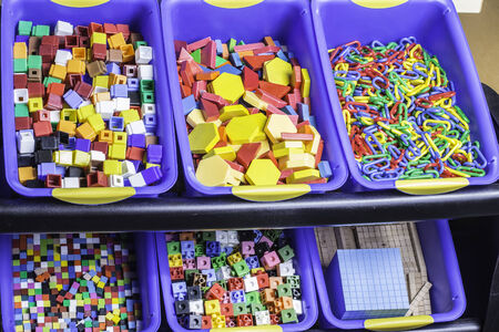 Large bins of educational and building blocks used in a classroom.