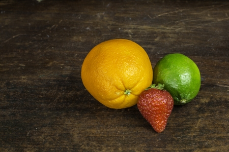 A selection of fruit sitting on an old piece of wood.の写真素材