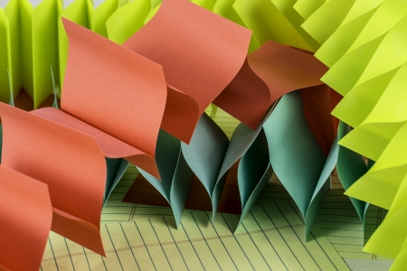Accordian style colorful note paper sitting on top of a desk.の写真素材