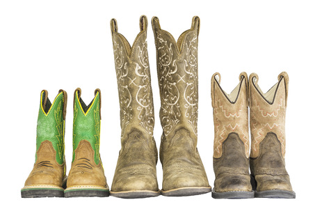A row of three pairs of cowboy western boots isolated on a white.の写真素材