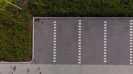A bird's eye view aerial shot of an empty parking lot.