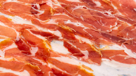 Thinly sliced Italian parma ham is ready to be eaten.の写真素材