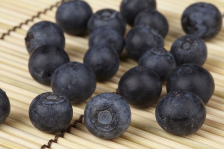 Blueberries on a straw matの写真素材