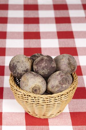 Basket of beetroot on checkered tableclothの写真素材