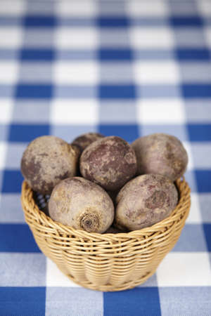 Basket of beetroot on checkered tableclothの写真素材