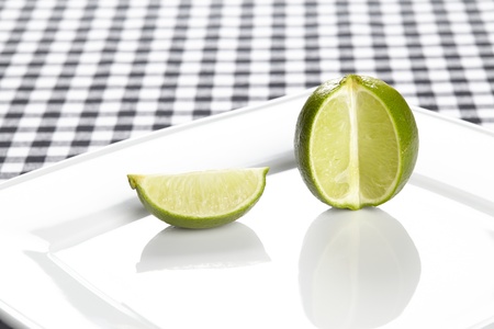 A single lime on a porcellain plate.の写真素材