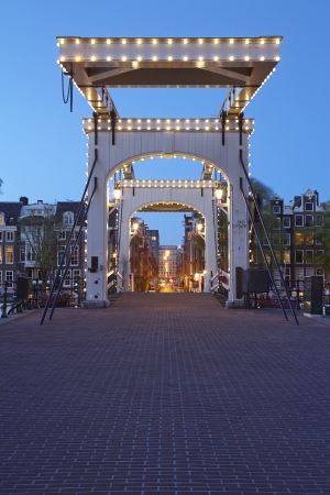 An drawbridge in the capitol of the Netherlands, Amsterdam in the evening (dusk).の写真素材