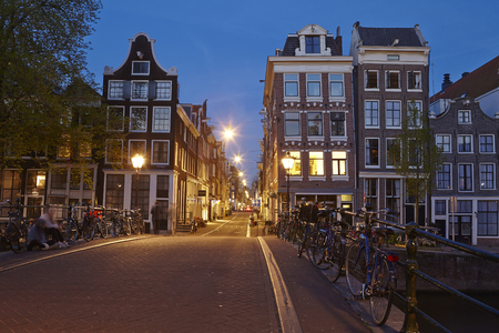 Evening scenery and shows some old houses and a street in Amsterdam (Netherlands).のeditorial素材