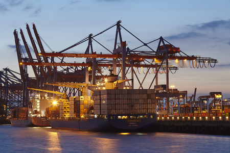 Container vessel Evridiki G is loaded/unloaded at the terminal Burchardkai in the deepwater port Hamburg-Waltershof in the evening of May 2014, 15.のeditorial素材