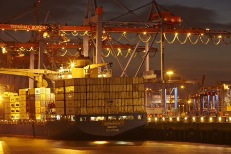 Container vessel Evridiki G at the container terminal Burchardkai in the deepwater port Hamburg-Waltershof taken in the late evening of May 2014, 15.のeditorial素材