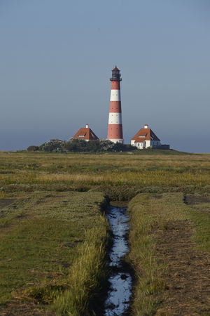 Landscape with salt meadows anad the light house Westerhever located near the coast of the North Sea taken on a sunny morning. This landscape is located near the coast of the North Sea (North Frisia, Germany, Schleswig Holstein):の写真素材