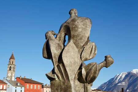 A sculpture is located at the Bay of Ascona (Switzerland, Ticino, Lake Maggiore) and is taken at daylight with a bright blue sky.の写真素材