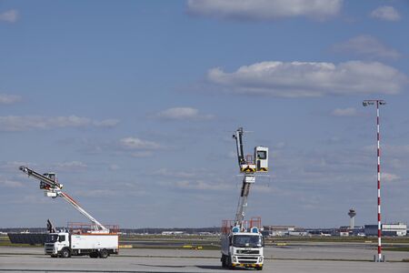 Some service vehicles for cleaning airplanes at the airport of Frankfurt (Germany) taken on April...