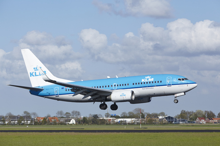 A Boeing 737-7K2 of KLM lands at Amsterdam Airport Schiphol (The Netherlands, AMS) on May 7, 2015. The name of the runway is Polderbaan.のeditorial素材