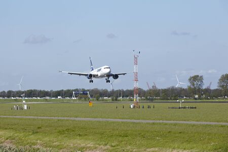 An Airbus A318-111 of Tarom lands at Amsterdam Airport Schiphol (The Netherlands, AMS) on May 7, 2015. The name of the runway is Polderbaan.のeditorial素材