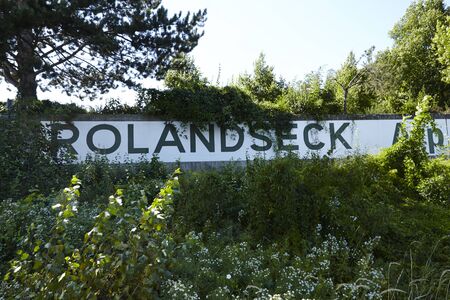 A direction sign Rolandseck (City Remagen, Germany, Rhineland-Palatinate) stands near the river Rhine on August 31, 2015.のeditorial素材