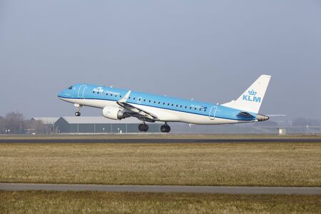 An Embraer ERJ-190STD of KLM Cityhopper takes off at Amsterdam Airport Schiphol (The Netherlands, AMS) on March 11, 2016. The name of the runway is Polderbaan.のeditorial素材