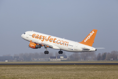 An Airbus A320-214 of EasyJet takes off at Amsterdam Airport Schiphol (The Netherlands, AMS) on March 11, 2016. The name of the runway is Polderbaan.のeditorial素材