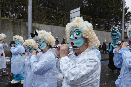 Some fully costumed carnival activists walk through the city during the carnival procession (cortege) of the Carnivel at Basel 2017 (Basle - Switzerland) on March 6, 2017.のeditorial素材