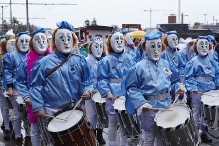Some fully costumed carnival activists walk through the city during the carnival procession (cortege) of the Carnivel at Basel 2017 (Basle - Switzerland) on March 6, 2017.のeditorial素材