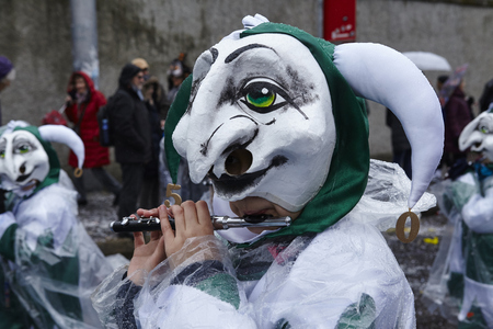 A fully costumed carnival activist walks through the city during the carnival procession (cortege) of the Carnivel at Basel 2017 (Basle - Switzerland) on March 6, 2017.のeditorial素材