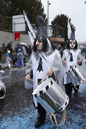 A fully costumed carnival activist walks through the city during the carnival procession (cortege) of the Carnivel at Basel 2017 (Basle - Switzerland) on March 6, 2017.のeditorial素材