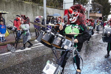 A fully costumed carnival activist walks through the city during the carnival procession (cortege) of the Carnivel at Basel 2017 (Basle - Switzerland) on March 6, 2017.のeditorial素材