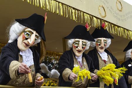 Some fully costumed carnival activists walk through the city during the carnival procession (cortege) of the Carnivel at Basel 2017 (Basle - Switzerland) on March 6, 2017.のeditorial素材
