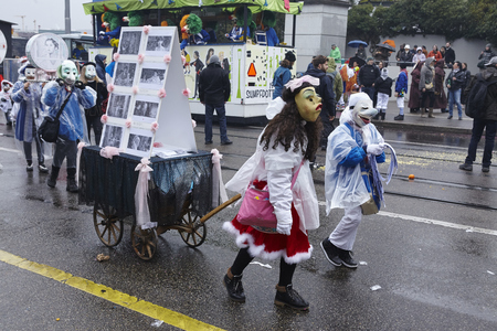 Some fully costumed carnival activists walk through the city during the carnival procession (cortege) of the Carnivel at Basel 2017 (Basle - Switzerland) on March 6, 2017.のeditorial素材