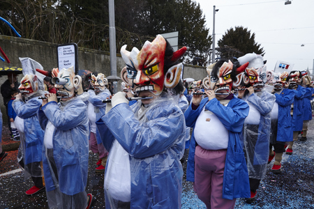 Some fully costumed carnival activists walk through the city during the carnival procession (cortege) of the Carnivel at Basel 2017 (Basle - Switzerland) on March 6, 2017.のeditorial素材