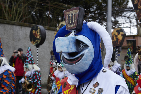 A fully costumed carnival activist walks through the city during the carnival procession (cortege) of the Carnivel at Basel 2017 (Basle - Switzerland) on March 6, 2017.のeditorial素材