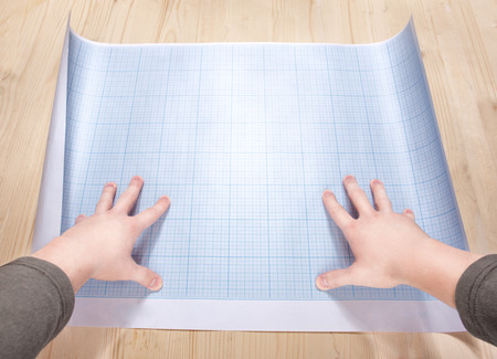 hands holding a blank of the blueprint