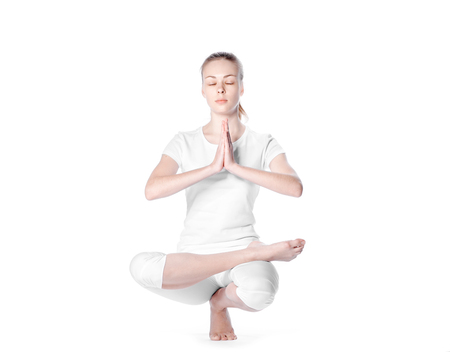 adult caucasian pretty girl doing diffucult exercise of yogaの写真素材