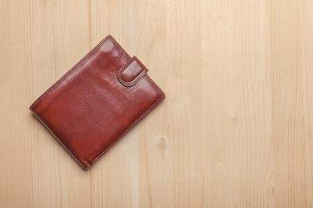 brown leather wallet on wooden table with copy space at right sideの写真素材