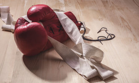 boxing-glove with white old hand-wrap on wooden surfaceの写真素材