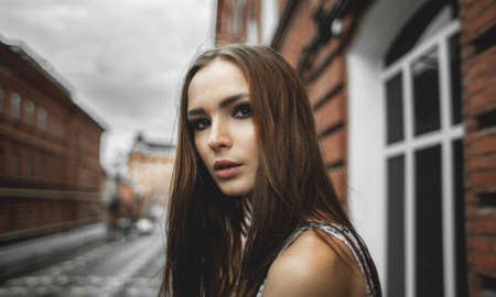 young beautiful woman in summer dress on street on cityの写真素材